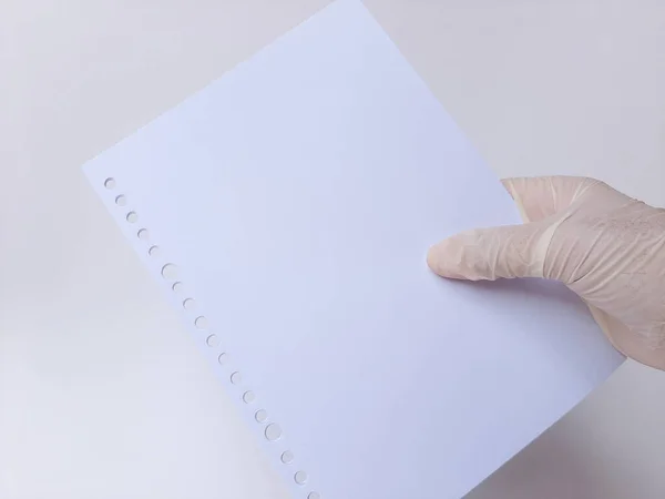 Hand White Latex Glove Holds Some Blank White Papers Isolated — Stock Photo, Image