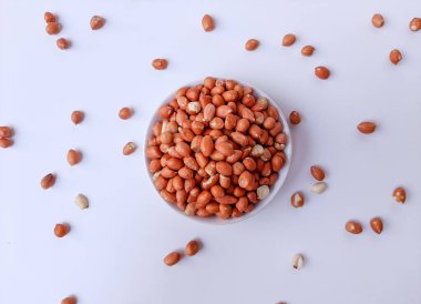 Fıstık ya da yerfıstığı ya da Arachis hipogaea, beyaz bir plakanın içinde, beyaz arka planda izole edilmiş.