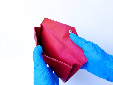 Beyaz lateks eldivenli bir el boş kırmızı bir çanta gösteriyor. Beyaz bir arkaplanda izole edilmiş