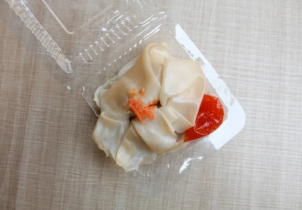 Affordable version of dumplings, with a small packet of sauce