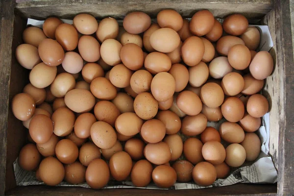 A box of chicken eggs in a wooden box