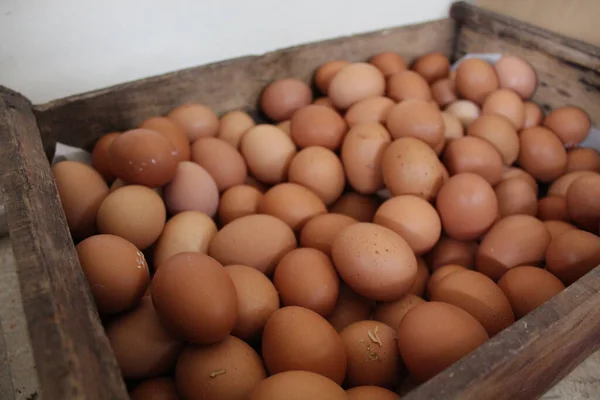 A box of chicken eggs in a wooden box