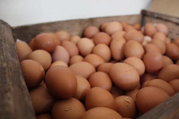 A box of chicken eggs in a wooden box