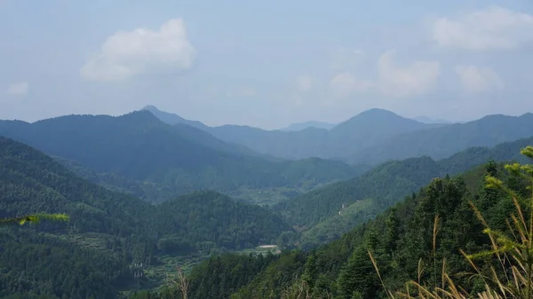 中国の田舎の背景として緑の森と小さな村と美しい山の風景 — ストック写真