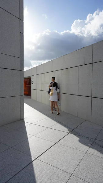 Two people walking on the roof of the builidngs with light and shadow in summer