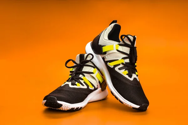 New running or unbranded running shoes on orange background. Mens sports shoes. A pair of sports shoes. Sport. — Fotografia de Stock