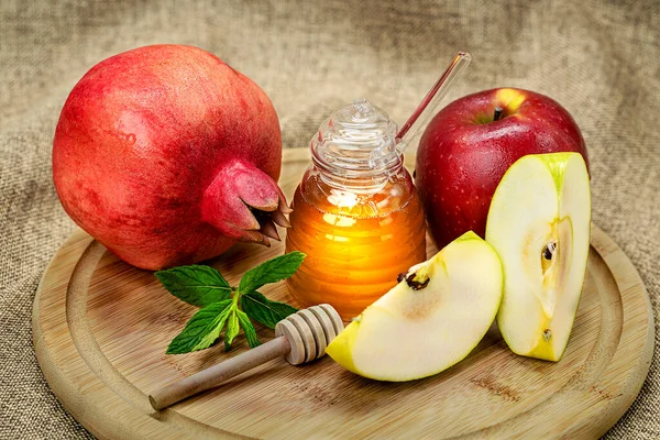 Rosh Hashanah. Pomegranate, apple and honey, traditional food for Jewish New Year celebration, Rosh Hashanah. Holidays.