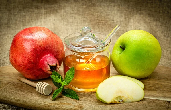 Rosh Hashanah. Pomegranate, apple and honey, traditional food for Jewish New Year celebration, Rosh Hashanah. Holidays.