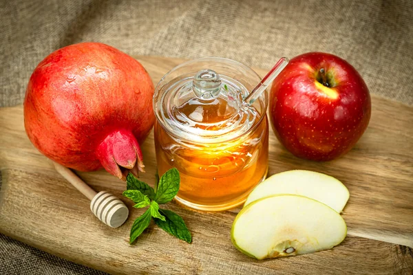 Rosh Hashanah. Pomegranate, apple and honey, traditional food for Jewish New Year celebration, Rosh Hashanah. Holidays.