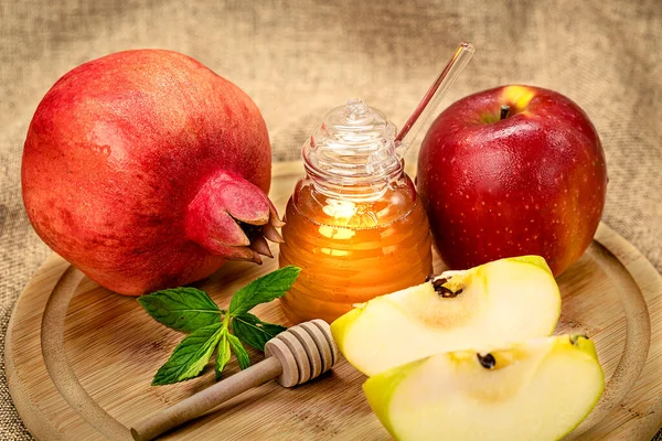 Rosh Hashanah. Pomegranate, apple and honey, traditional food for Jewish New Year celebration, Rosh Hashanah. Holidays.