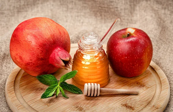 Rosh Hashanah. Pomegranate, apple and honey, traditional food for Jewish New Year celebration, Rosh Hashanah. Holidays.