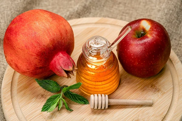 Rosh Hashanah. Pomegranate, apple and honey, traditional food for Jewish New Year celebration, Rosh Hashanah. Holidays.