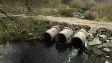 Beton atık boruları. Su akıntıları beton borulardan akar. Parktaki kirli su kütlesi. İHA 'dan ateş ediliyor. Hava fotoğrafçılığı.