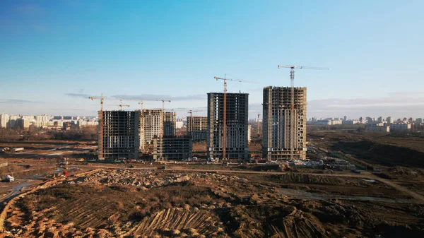 建設現場だ 近代的な複数階建ての建物の建設 建設クレーンの作業が見える 青空を背景に 空中写真 — ストック写真