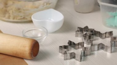 Bir kadın bisküvi kurabiyesi yapmak için hamur karıştırıyor. Marshmallow sandviçi pişiriyorum. Malzemeler ve aletler masaya serildi. Yakın çekim...