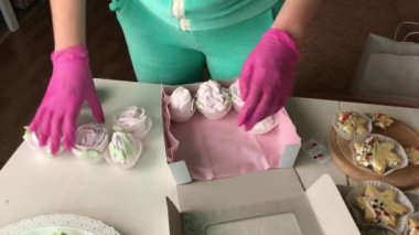 Bir kadın lokumları bir kutuya koyuyor. Değişik şekil ve boyutlarda şekerlemeler. Şekerleme gülleri. Şekerlemeler masanın üzerine yayılmış..