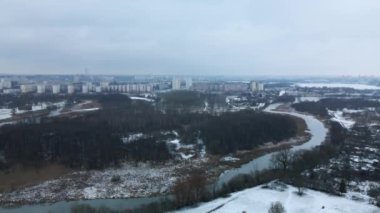 Nehrin üzerinden karla kaplı bir şehir parkına uçacağız. Hava fotoğrafçılığı.