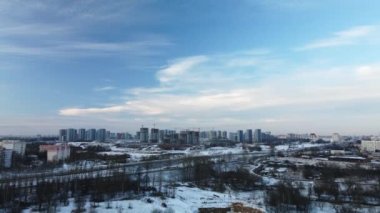 Flying in a suburban park. City blocks are visible. Winter cityscape. Aerial photography.