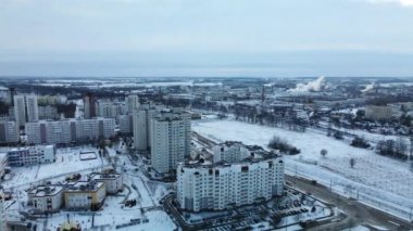 Flying in a suburban park. City blocks are visible. Winter cityscape. Aerial photography.