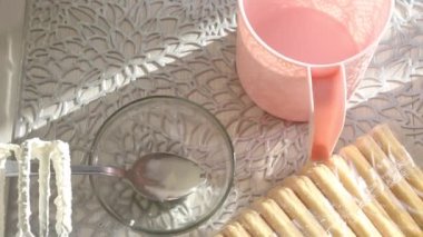 Pastanın malzemeleri masanın üzerine serildi. Savoiardi kurabiyeli kek ve marshmallow gülleri. Yakın plan..