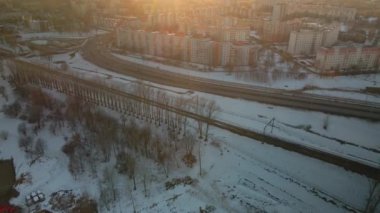 Büyük bir şehrin banliyösü. Uçuşun yüksekliğinden bir blok ötede. Yoğun trafiği olan şehir otoyolu. Kış şehri manzarası. Gün batımında altın saat. Hava fotoğrafçılığı.