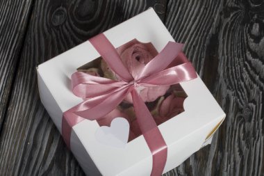 Güller, laleler ve marşmelovlardan kasımpatılar. Zephyr çiçekleri. El işi ambalajında. Kurdeleyle bağlanmış.