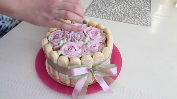 Woman Adjusts Cake Elements Cake Savoiardi Cookies Marshmallow Roses Tied — Stock Video