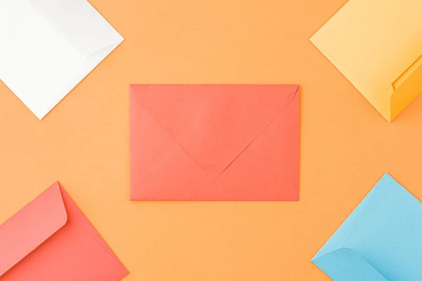 Mailing envelopes on orange background. — Stok fotoğraf