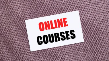 Kahverengi arkaplanda, üzerinde ONLINE COURSES yazan beyaz dikdörtgen bir kart