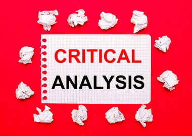 On a bright red background, white crumpled sheets of paper and a sheet of paper with the text CRITICAL ANALYSIS clipart