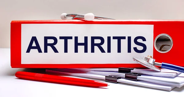 Masaüstünde Steteskop Belgeler Bir Kalem Arthritis Metninin Olduğu Kırmızı Bir - Stok İmaj