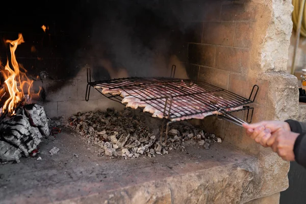 Неузнаваемый человек бросает гриль с сырым мясом на барбекю — стоковое фото