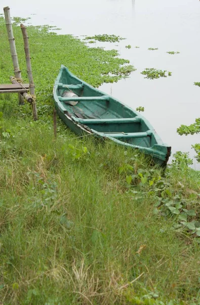 川沿いのポールに結び付けられた小さなボート — ストック写真