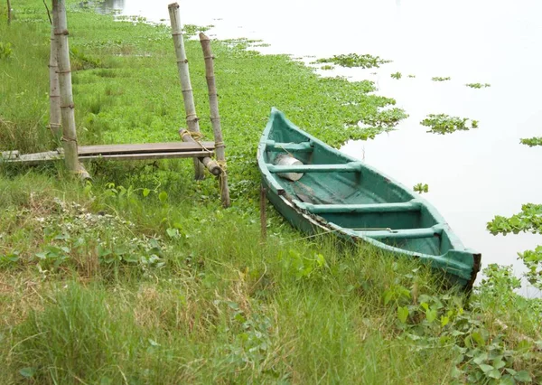 Маленькая Лодка Привязанная Полюсу Вдоль Реки — стоковое фото