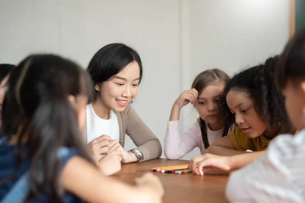 Pupils Playing Games Asian Female Teacher Together Classroom Group Diverse — стоковое фото