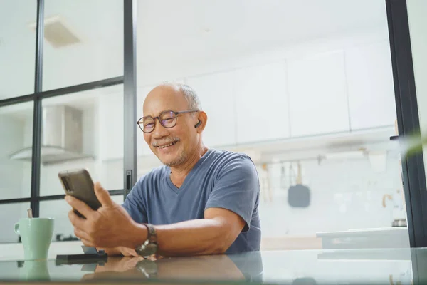 Happy Senior Mature Male Sitting Using Smartphone Home Leisure Active — Photo