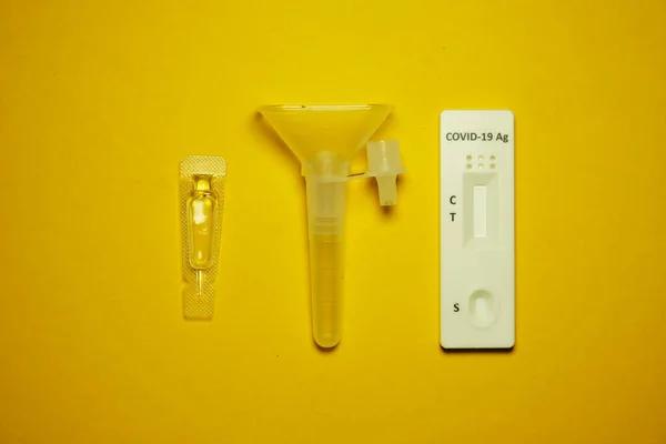 Covid Antigen Salivaの写真黄色の背景に迅速な自己テストキット — ストック写真