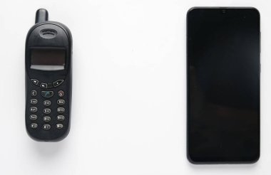 A picture of old phone and smartphone on white background. 