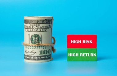 A picture of fake mony with red and green wooden block written high risk, high return.