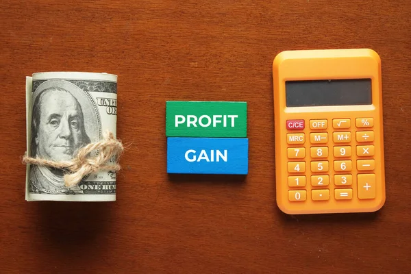Picture Fake Money Profit Gain Word Wooden Domino Calculator Profit — стоковое фото