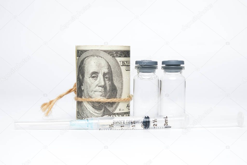 A picture of fake money, two dosses of vaccines and syringe. Lot of money been spend to the household for vaccination programme.