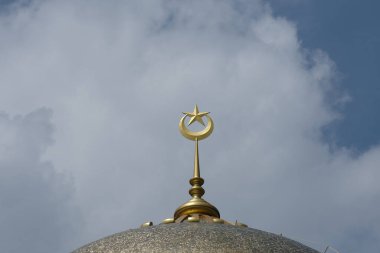 Close up with noise effect picture of new golden spike, moon and star at the mosque dome during beautiful cloud insight.