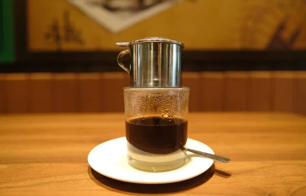 Selective focus with noise effect of Vietnamese coffee been prepare in restaurant