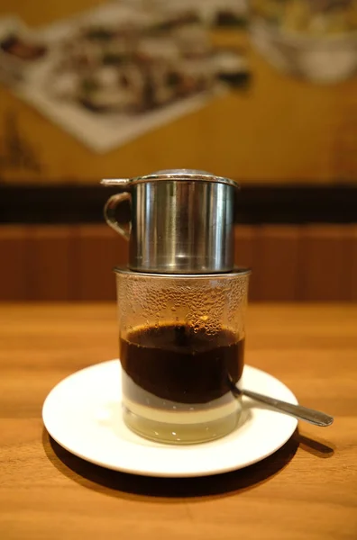 Selective focus with noise effect of Vietnamese coffee been prepare in restaurant