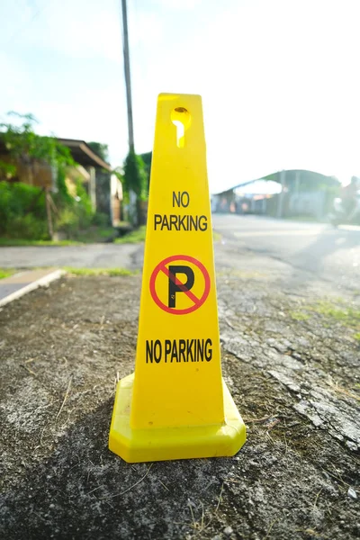 Selective focus picture of no parking cone sign at private parking space