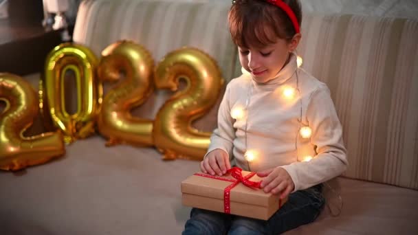 Happy Girl Christmas Reindeer Headband Opens Gift Box Background Golden — Stock Video