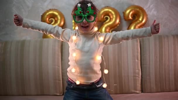 Happy Girl Puts New Year Glasses Tree Rejoices Christmas Merry — Stock Video