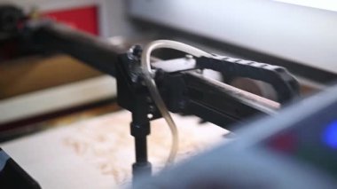 Tahta oyma lazer yakma makinesi, endüstriyel lazer kesici, görüntü transferi. Endüstriyel lazer kontrplak tabakasında bir kalıp oluşturuyor ve yavaş hareket ediyor, yaklaş. Lazerle yanan modern ahşap.