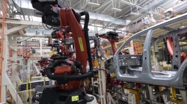 Otomatik otomobil montajı robotlar tarafından, üretim güvenliği modern bir fabrikada