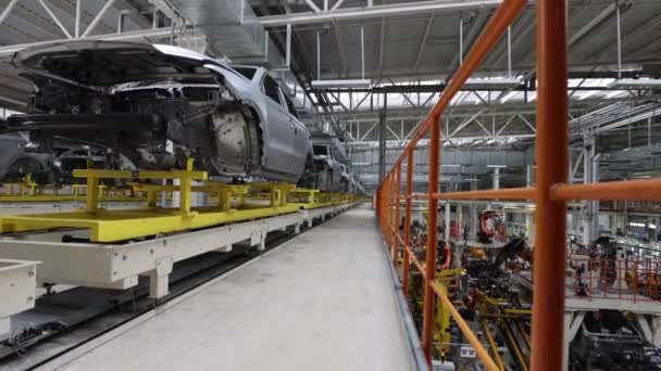 Primed car body before painting, automatic conveyor, production safety — Stock Video